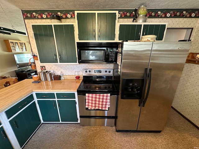 kitchen featuring carpet flooring, appliances with stainless steel finishes, and a textured ceiling