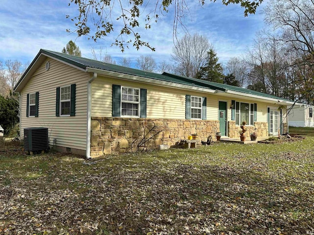 ranch-style home with central air condition unit