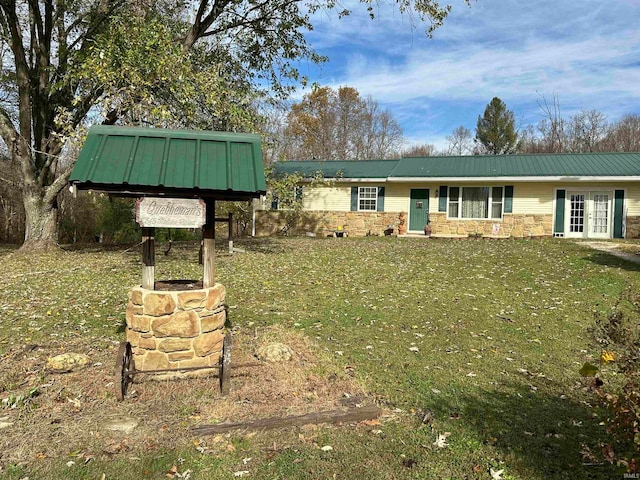 view of front of property with a front lawn and french doors