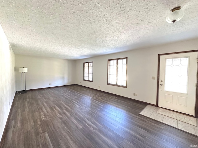 entryway featuring a textured ceiling and dark hardwood / wood-style floors