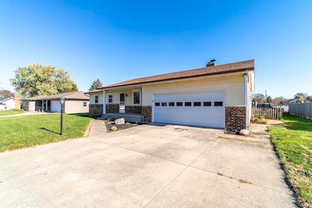 ranch-style house featuring a front lawn and a garage