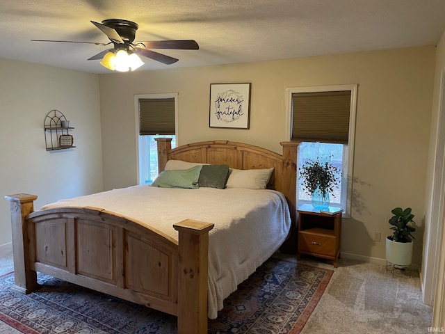 carpeted bedroom with multiple windows, a textured ceiling, and ceiling fan