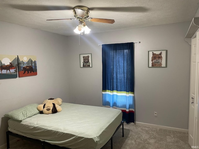 carpeted bedroom with a textured ceiling and ceiling fan