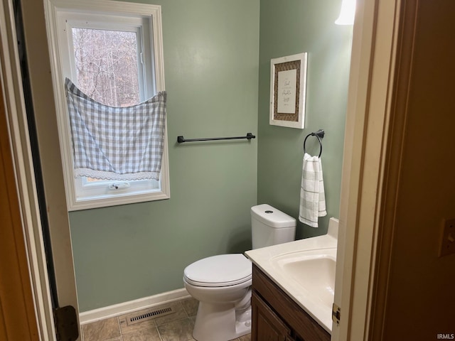 bathroom with vanity, tile patterned floors, and toilet