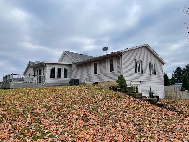 rear view of house with central AC unit