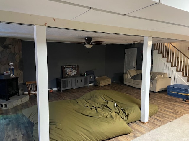 basement with wood-type flooring and ceiling fan