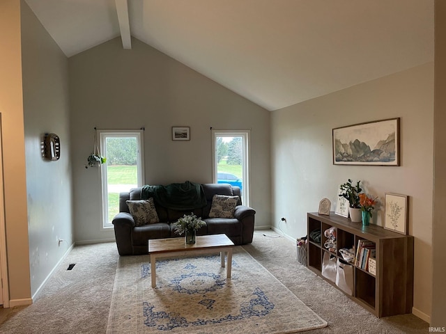 carpeted living room featuring high vaulted ceiling, a healthy amount of sunlight, and beam ceiling