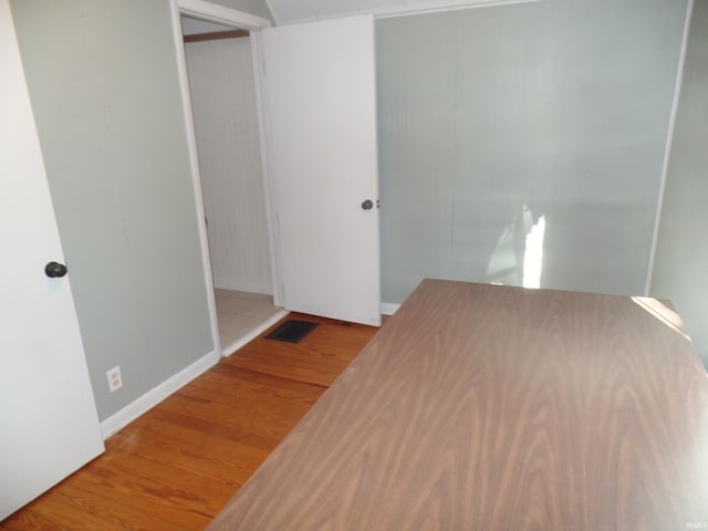 unfurnished bedroom with hardwood / wood-style flooring