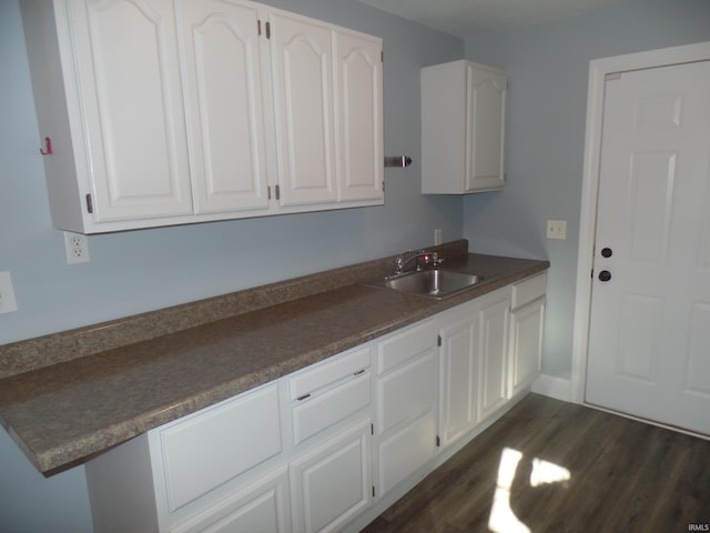 kitchen with white cabinetry, sink, and dark hardwood / wood-style floors