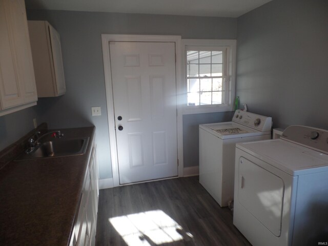 laundry area featuring cabinets, separate washer and dryer, sink, and dark hardwood / wood-style flooring