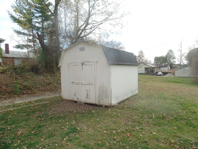 view of outdoor structure featuring a lawn