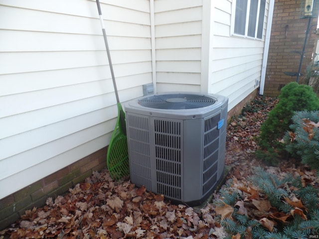 exterior details featuring central AC unit and wooden walls