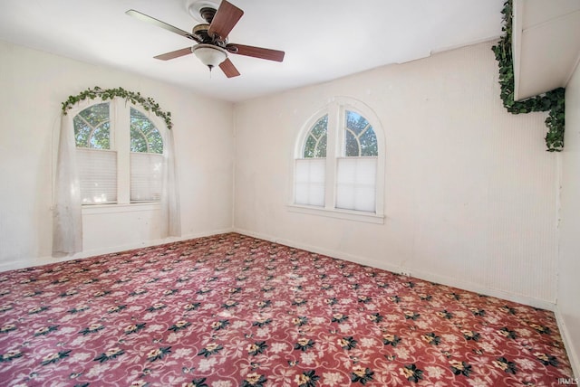 spare room featuring ceiling fan and a healthy amount of sunlight