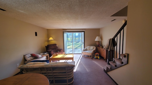 carpeted living room featuring a textured ceiling