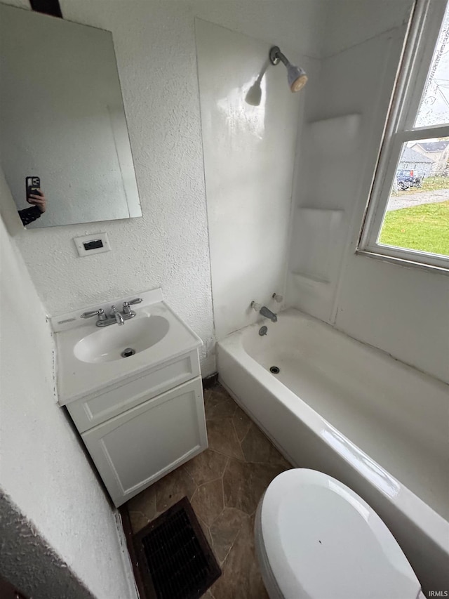 full bathroom with shower / washtub combination, vanity, and toilet