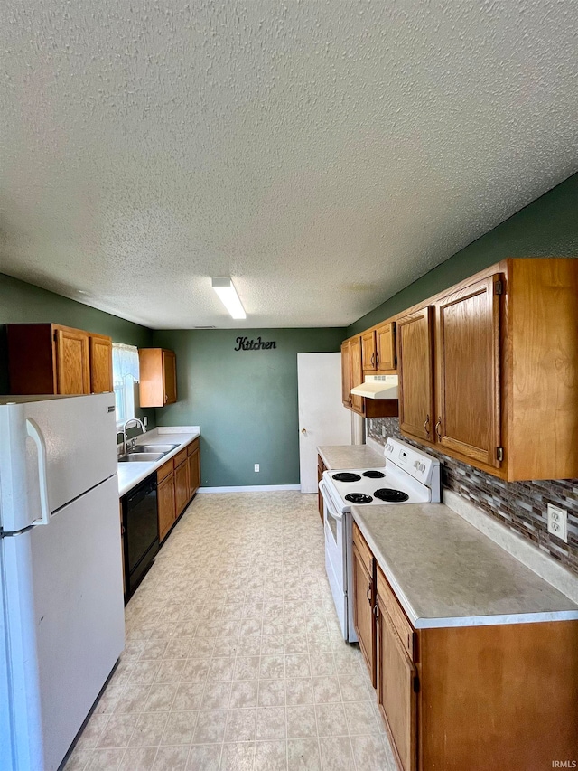 kitchen featuring white appliances, a textured ceiling, sink, and backsplash