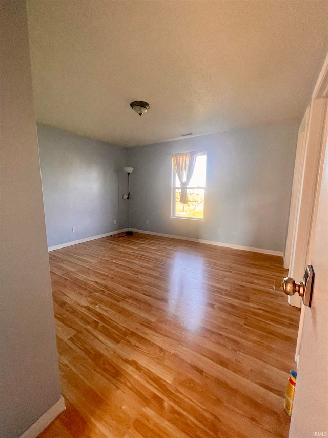 spare room featuring light hardwood / wood-style flooring