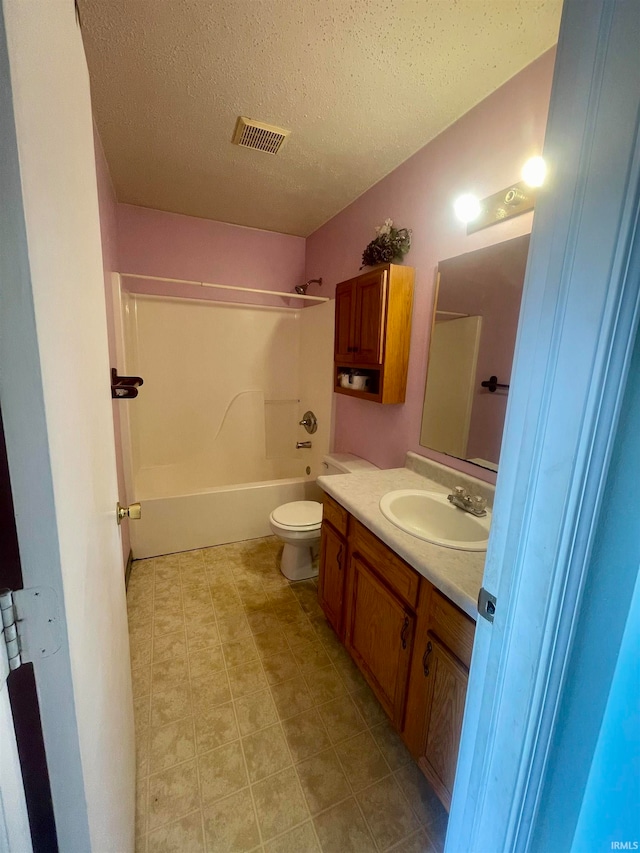 full bathroom with toilet, tile patterned flooring, a textured ceiling, shower / bathing tub combination, and vanity