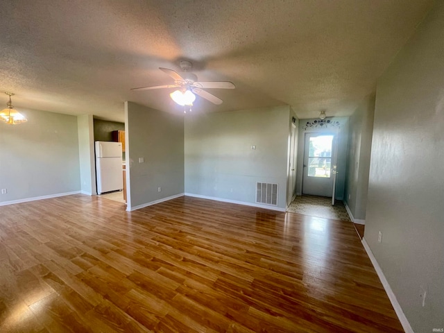 interior space featuring hardwood / wood-style floors, a textured ceiling, and ceiling fan