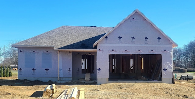 property in mid-construction featuring roof with shingles