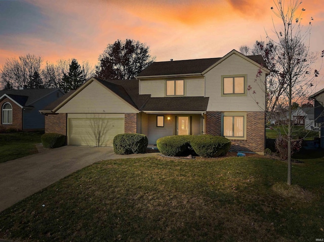 view of property featuring a garage and a yard