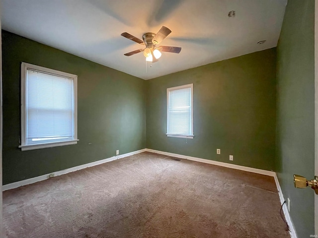 carpeted spare room with ceiling fan