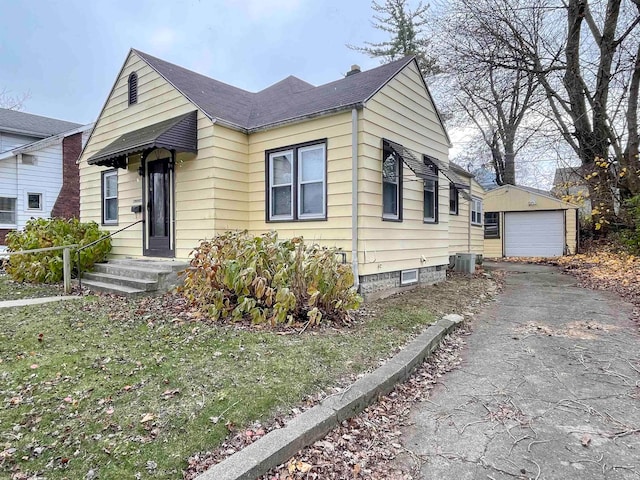 bungalow-style house featuring central AC unit, an outdoor structure, and a garage