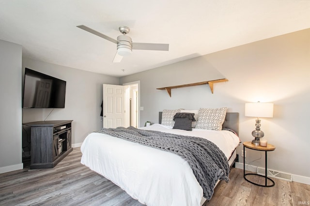 bedroom with hardwood / wood-style flooring and ceiling fan