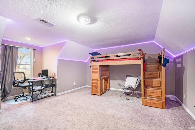 office featuring a textured ceiling, carpet flooring, and lofted ceiling