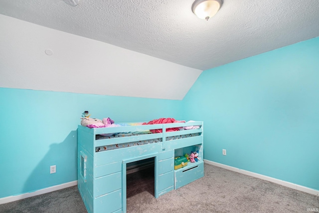 carpeted bedroom featuring lofted ceiling and a textured ceiling