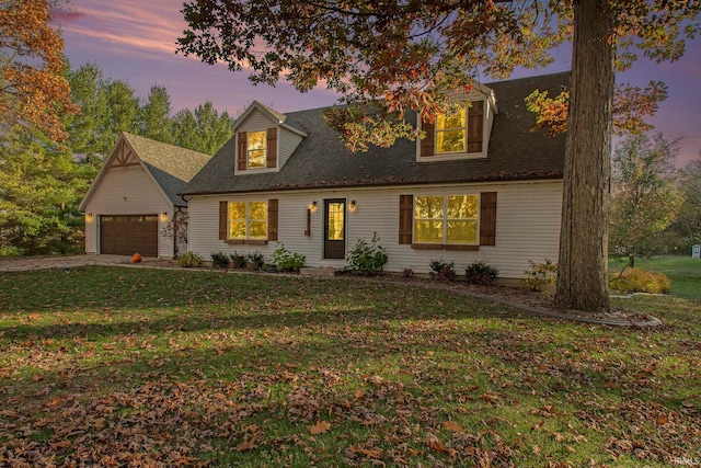 cape cod home with a garage and a yard