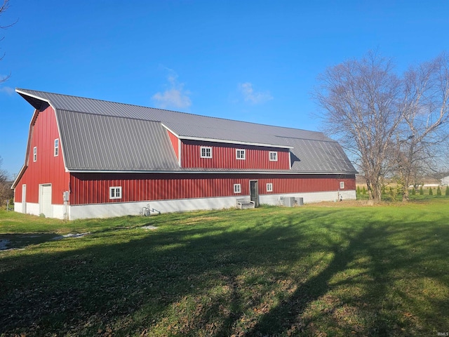 view of side of home with cooling unit and a yard