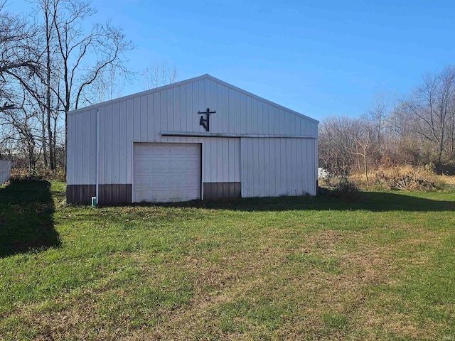 view of outdoor structure with a lawn and a garage