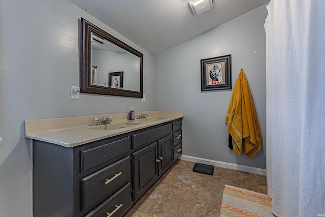 bathroom featuring vanity and vaulted ceiling