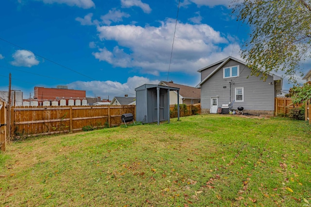 rear view of house with a storage shed and a lawn