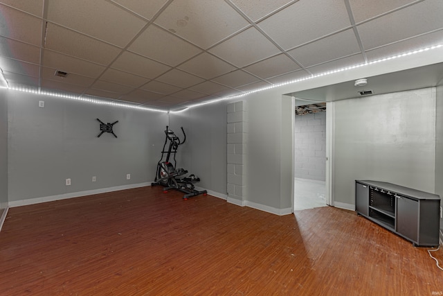 basement featuring wood-type flooring and a drop ceiling