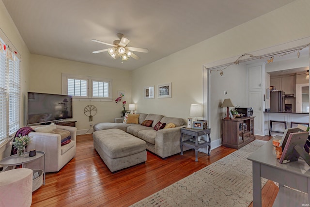 living room featuring ceiling fan and hardwood / wood-style floors