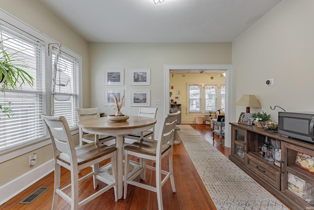 dining space featuring hardwood / wood-style flooring and a wealth of natural light