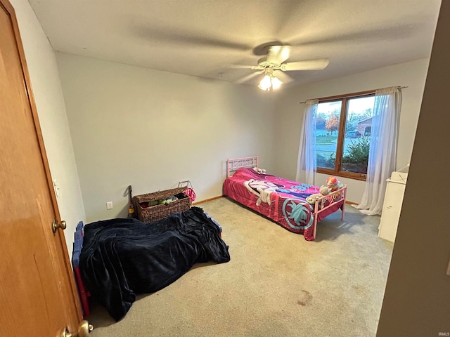 bedroom featuring ceiling fan and light colored carpet