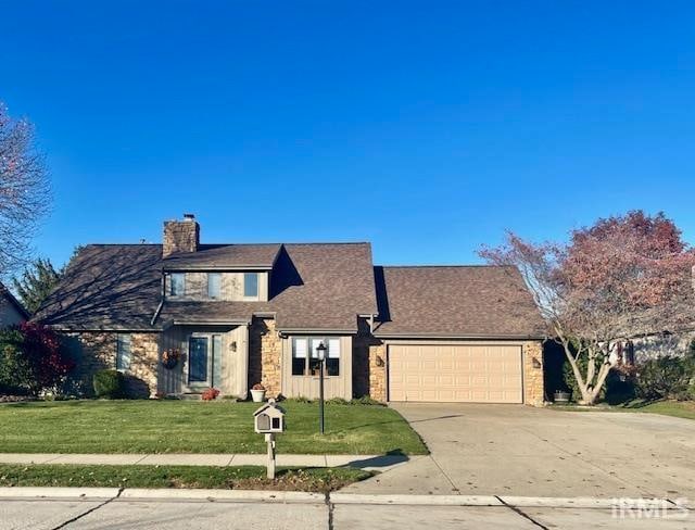 view of property with a front yard and a garage