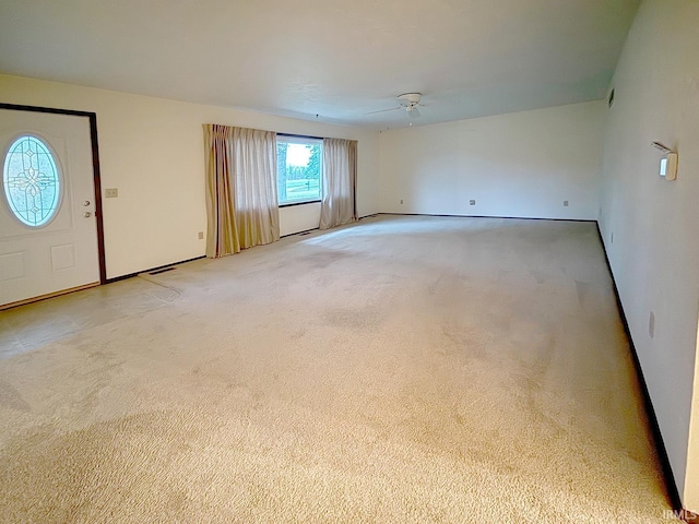 interior space with carpet and ceiling fan