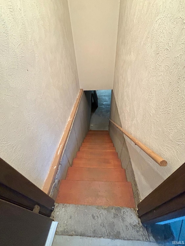 stairs with wood-type flooring