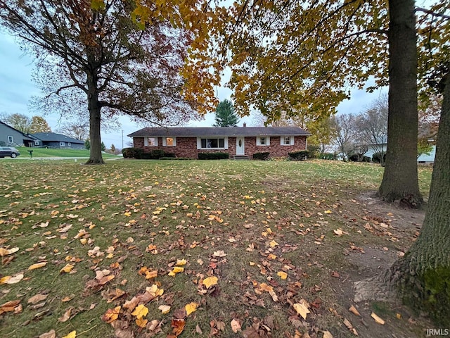 ranch-style home with a front lawn