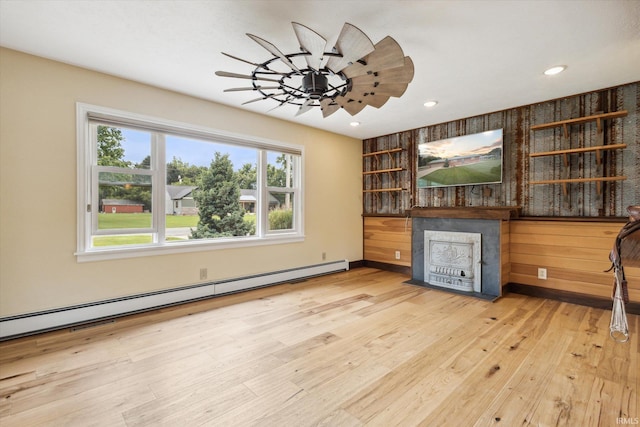 bar featuring baseboard heating, light wood-type flooring, and ceiling fan