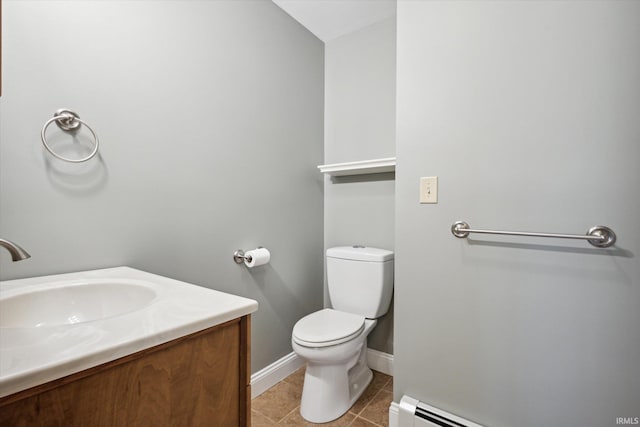 bathroom with tile patterned flooring, a baseboard radiator, vanity, and toilet