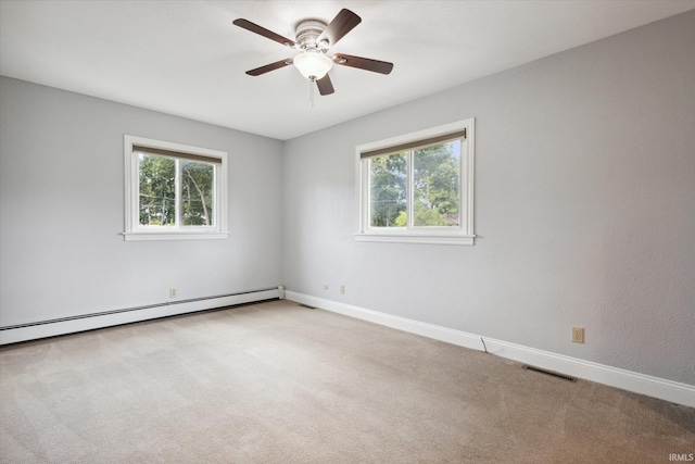 empty room with carpet flooring, a baseboard heating unit, and ceiling fan