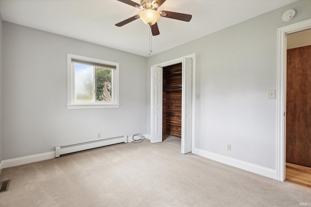 unfurnished bedroom with ceiling fan, baseboard heating, light carpet, and a closet