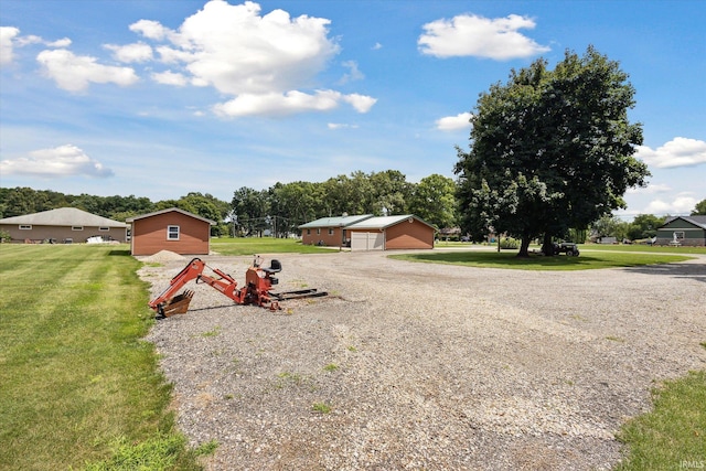 view of yard featuring a garage and an outdoor structure