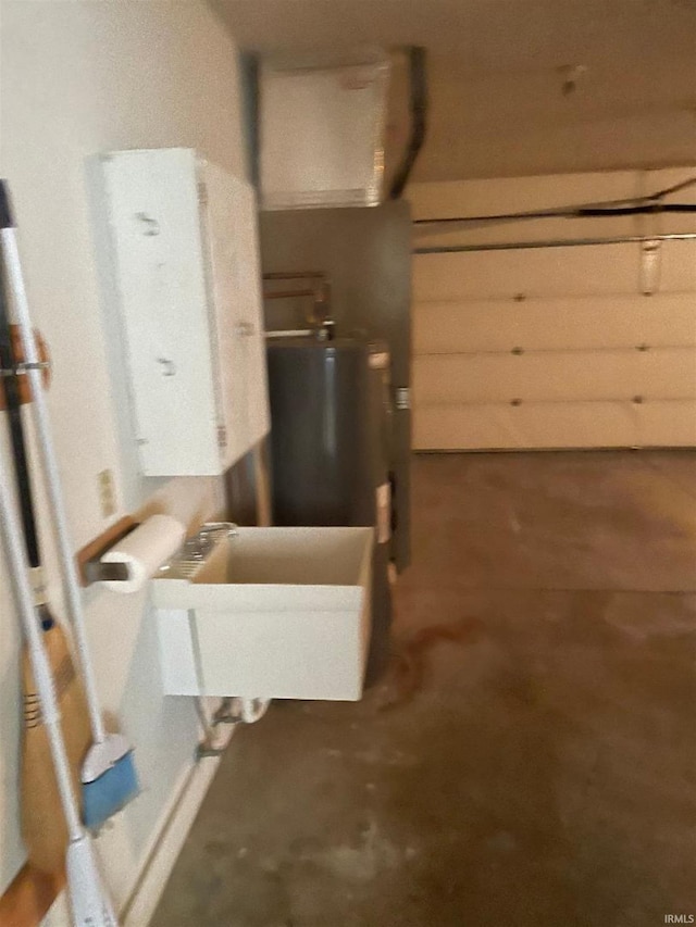 garage featuring water heater and sink