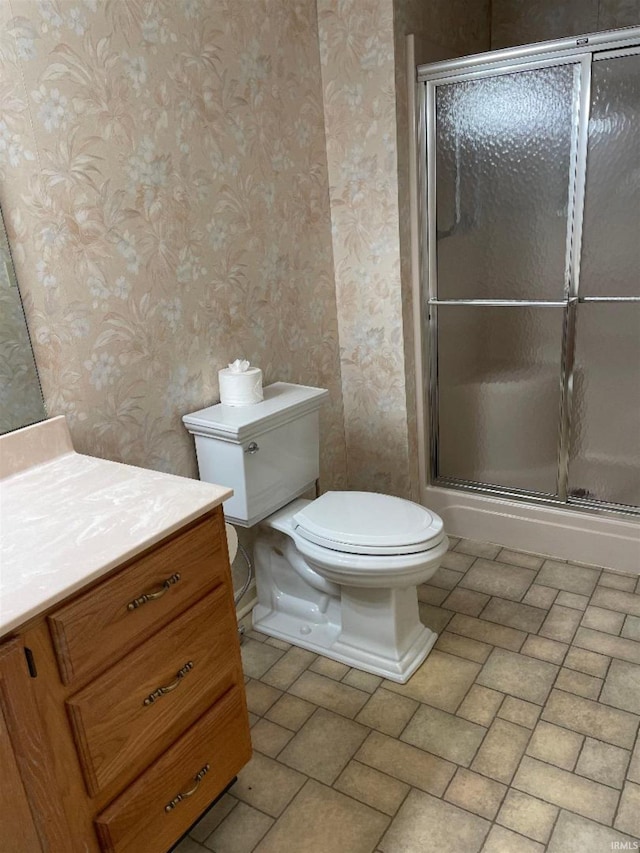 bathroom featuring walk in shower, vanity, and toilet